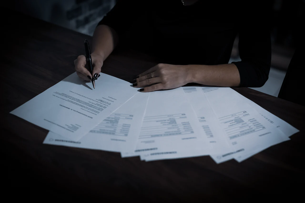 Signing contract documents at a desk