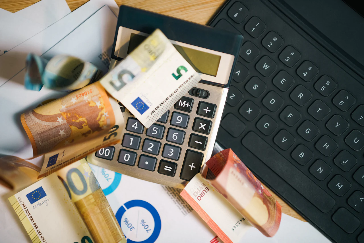 Calculator and banknotes on a desk