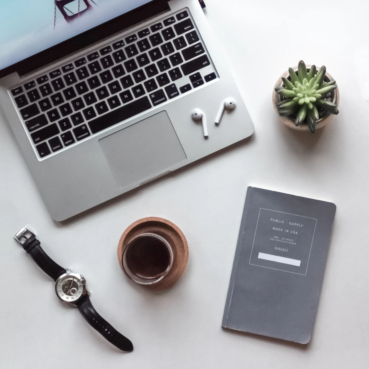 Laptop, notebook and coffee on a clean desk